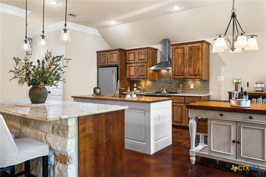 2405 Twin Ridge Court Belton, TX 76513 - Photo 11 of 30 a kitchen with stainless steel appliances kitchen island granite countertop a table chairs in it and wooden floors