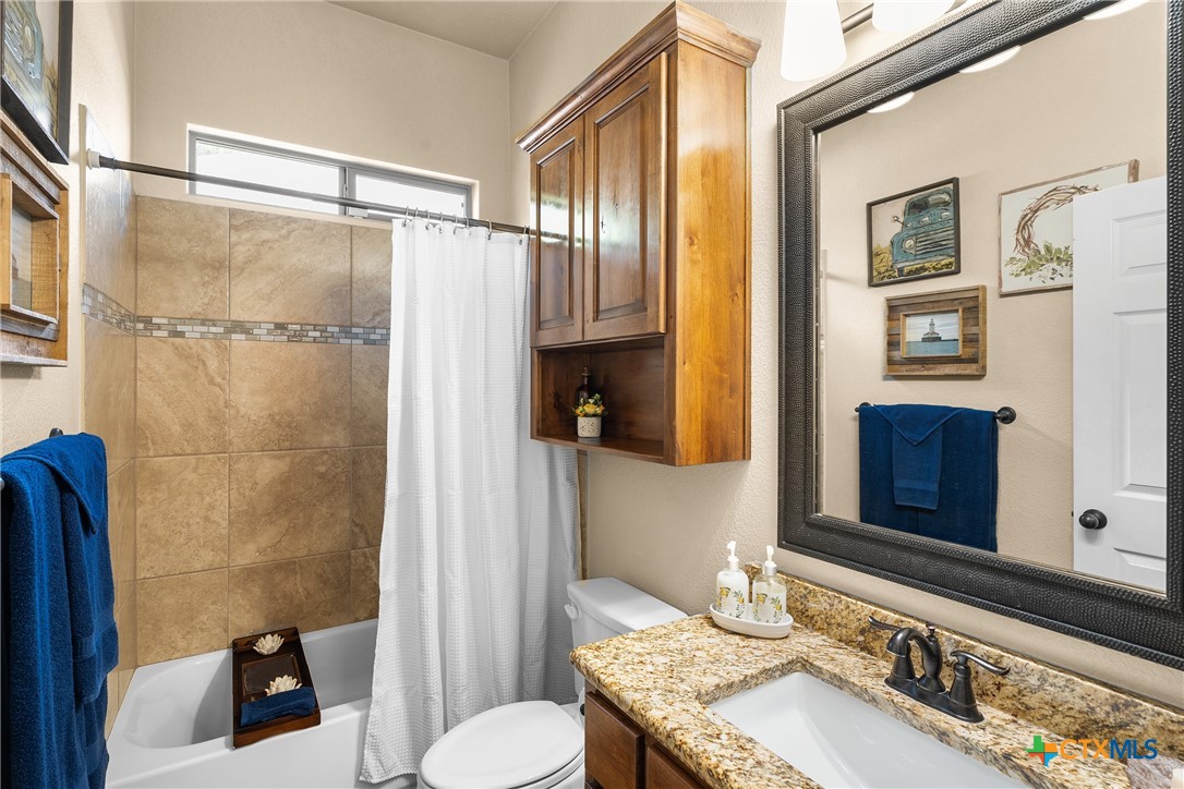 2405 Twin Ridge Court Belton, TX 76513 - Photo 19 of 30 a bathroom with a granite countertop sink toilet and shower