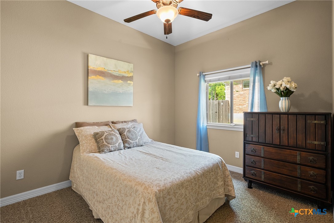 2405 Twin Ridge Court Belton, TX 76513 - Photo 20 of 30 a bedroom with a bed and wooden floor