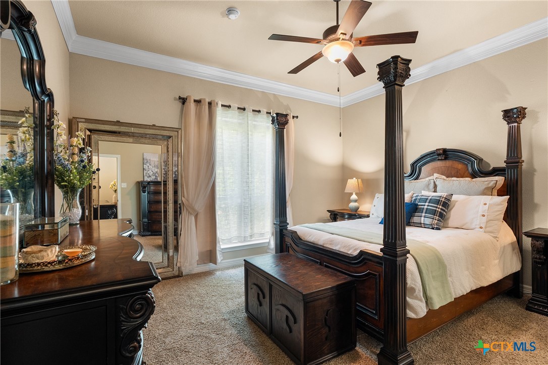 2405 Twin Ridge Court Belton, TX 76513 - Photo 21 of 30 a bedroom with bed and a chandelier