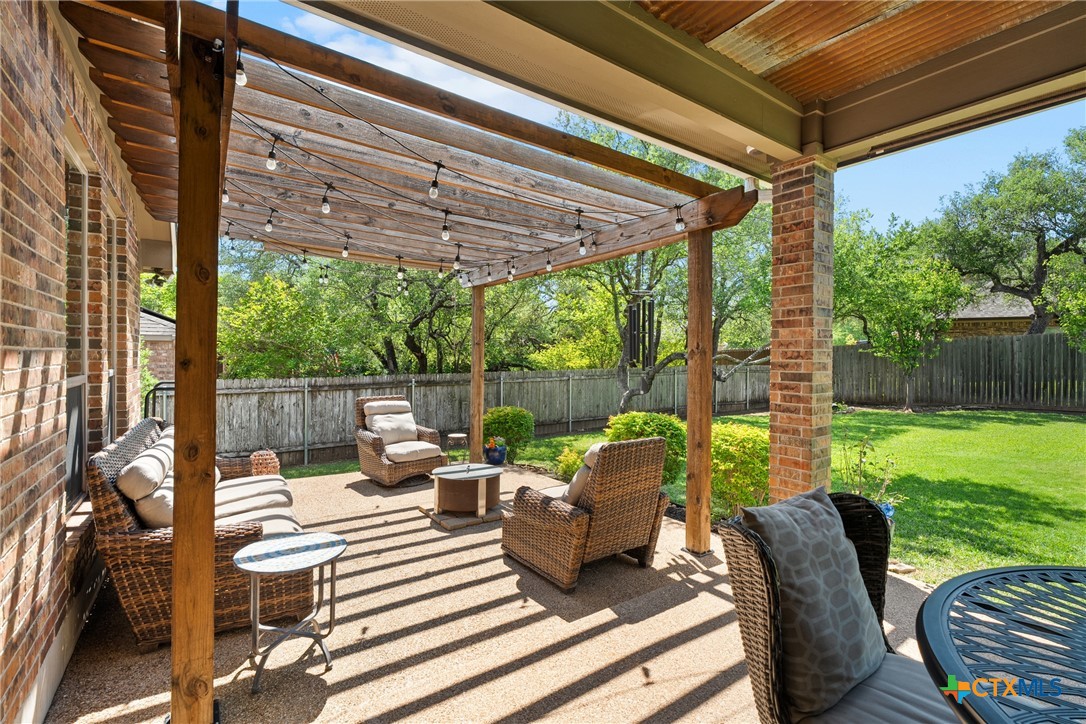 2405 Twin Ridge Court Belton, TX 76513 - Photo 26 of 30 a view of a patio with couches chairs potted plants and a big yard