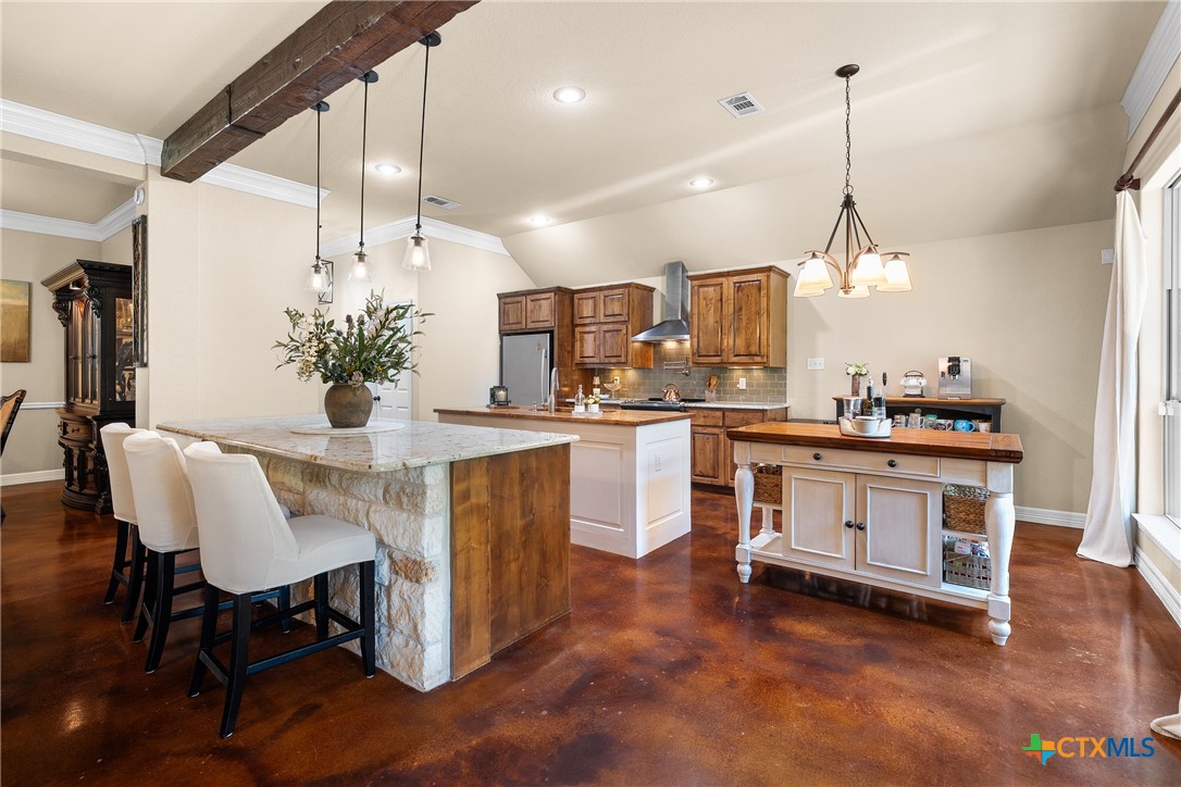 2405 Twin Ridge Court Belton, TX 76513 - Photo 10 of 30 a kitchen with kitchen island a stove a table and chairs in it