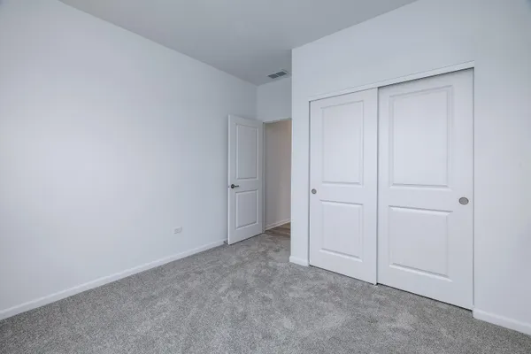 a view of an empty room and closet area
