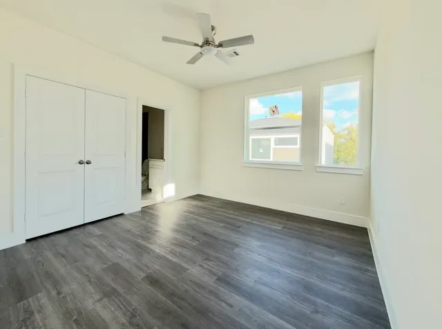 a view of a hallway with wooden floor and staircase