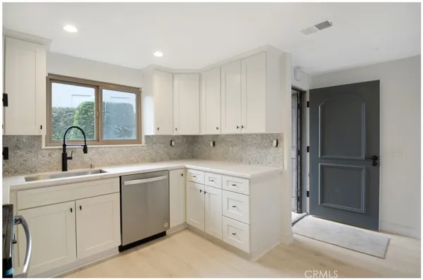 a kitchen with a sink and refrigerator