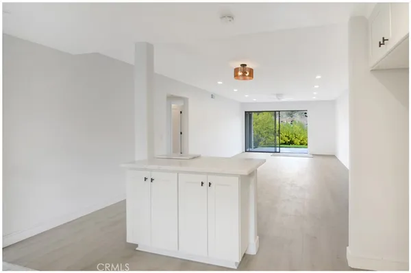 a view of cabinets with wooden floor and windows