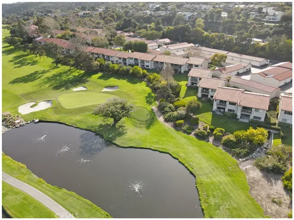 an aerial view of a pool residential houses with yard