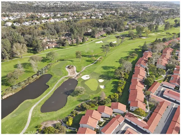 an aerial view of a residential houses with yard