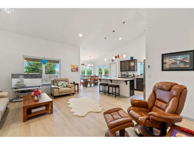 a living room with furniture and kitchen view