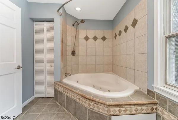 a bathroom with a tub and shower