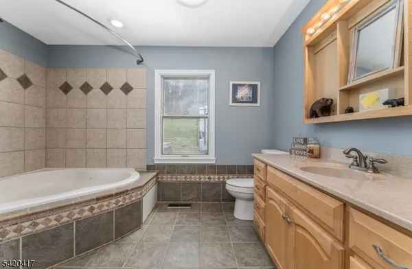 a bathroom with a sink a bathtub and a window