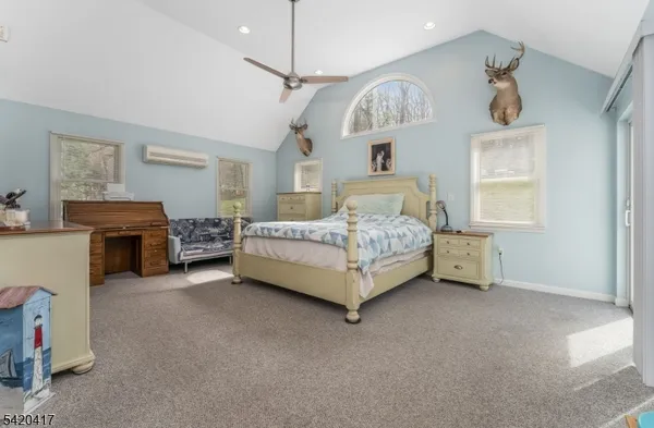 a bedroom with furniture and a chandelier