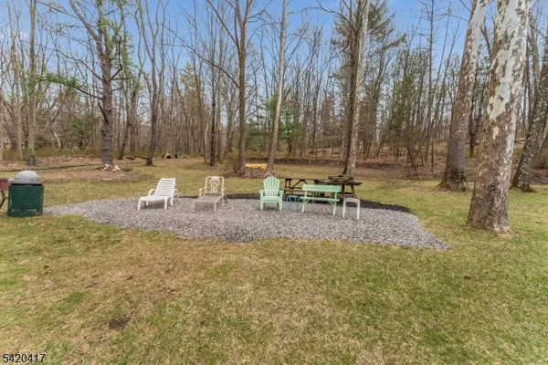 a view of a chair and table in the garden