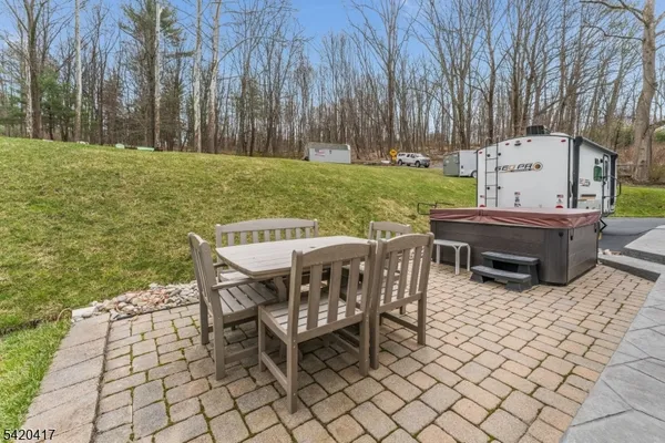 a view of a patio with table and chairs with wooden fence and plants