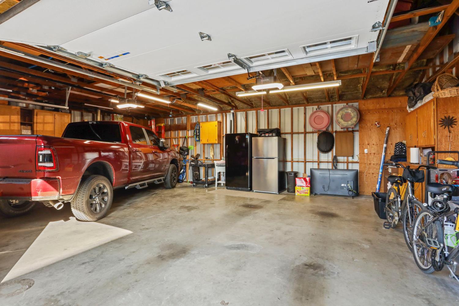23346 Frederick Road Ripon, CA 95366 - Photo 82 of 96 a view of a garage with parked cars