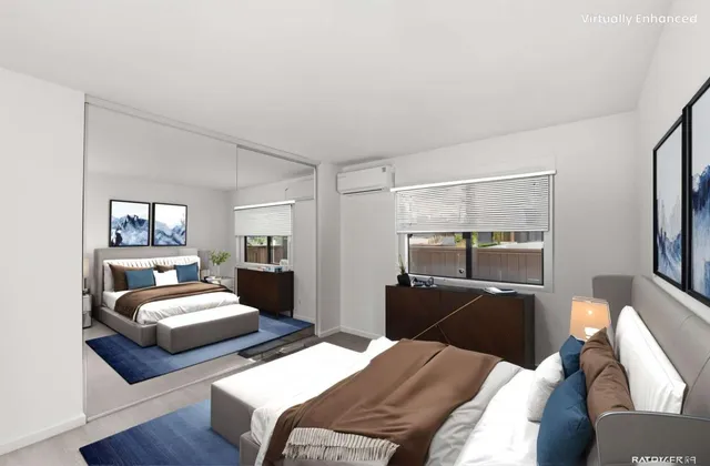 a bedroom with two beds and a mirror