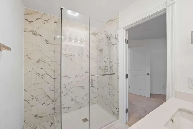 a bathroom with a shower and a glass door