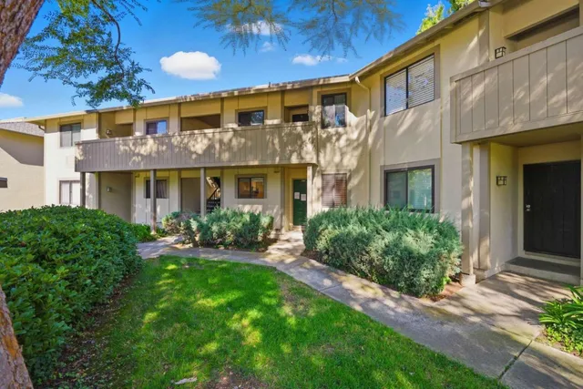 a view of a brick building next to a yard