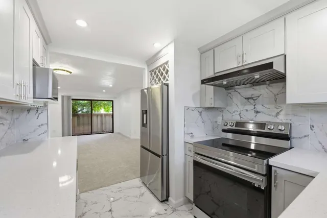 a kitchen with a stove and a refrigerator