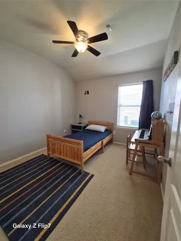 a bedroom with bed and window