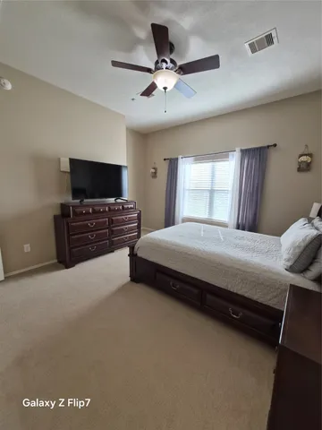 a bedroom with a bed and window