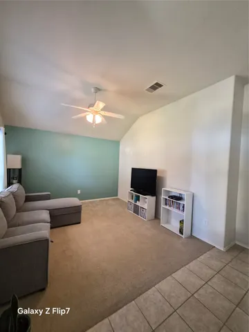 a bedroom with furniture and a flat screen tv