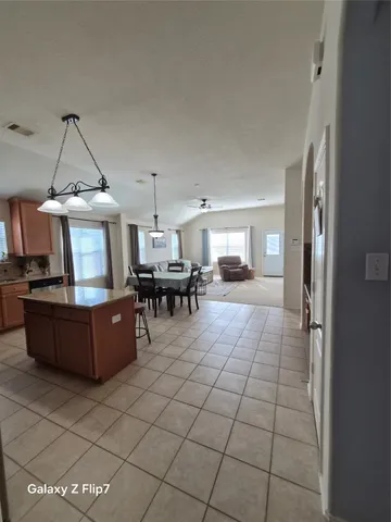 a room with furniture and a kitchen view