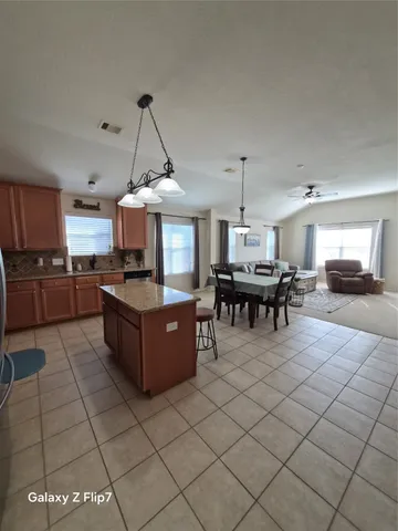 a kitchen with granite countertop a sink cabinets and stainless steel appliances