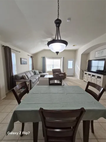 a large kitchen with stainless steel appliances granite countertop a stove and a refrigerator