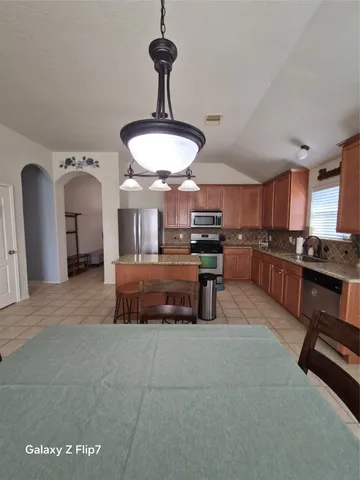 a living room with furniture and a lamp