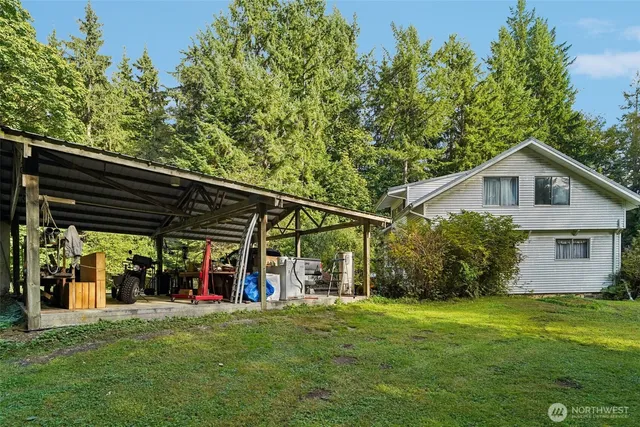 a view of a big house with a big yard and potted plants