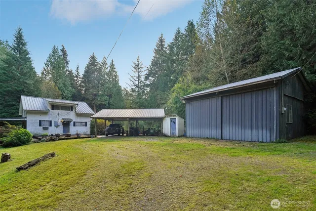 a view of a house with a yard and sitting area
