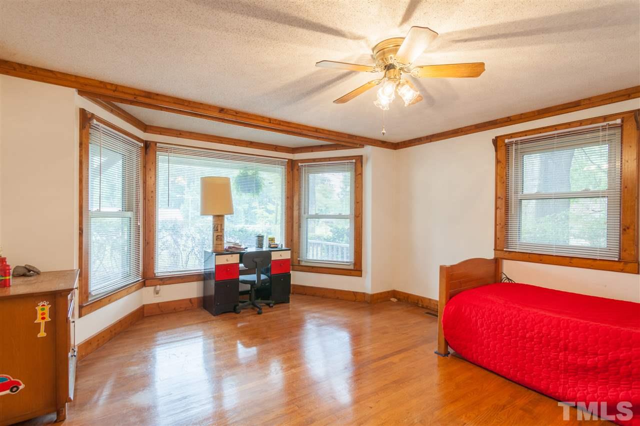 919 Grovemont Road Raleigh, NC 27603 - Photo 12 of 24 a living room with a bed furniture and a large window