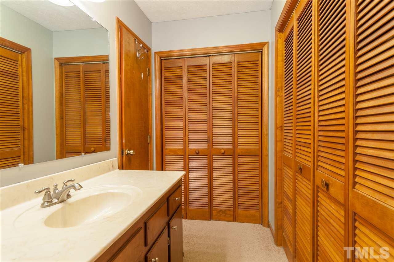 919 Grovemont Road Raleigh, NC 27603 - Photo 16 of 24 a bathroom with a sink and a mirror