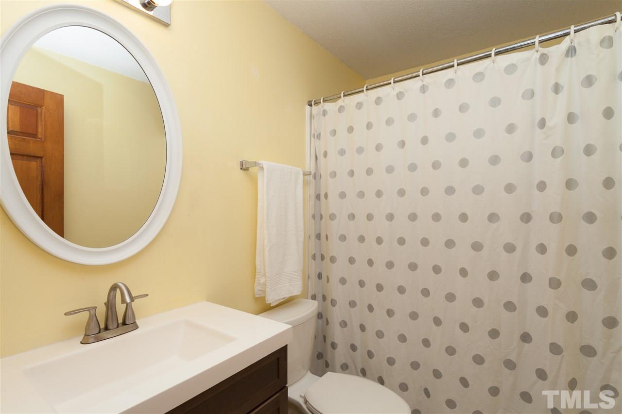 919 Grovemont Road Raleigh, NC 27603 - Photo 17 of 24 a bathroom with a sink a toilet and a mirror