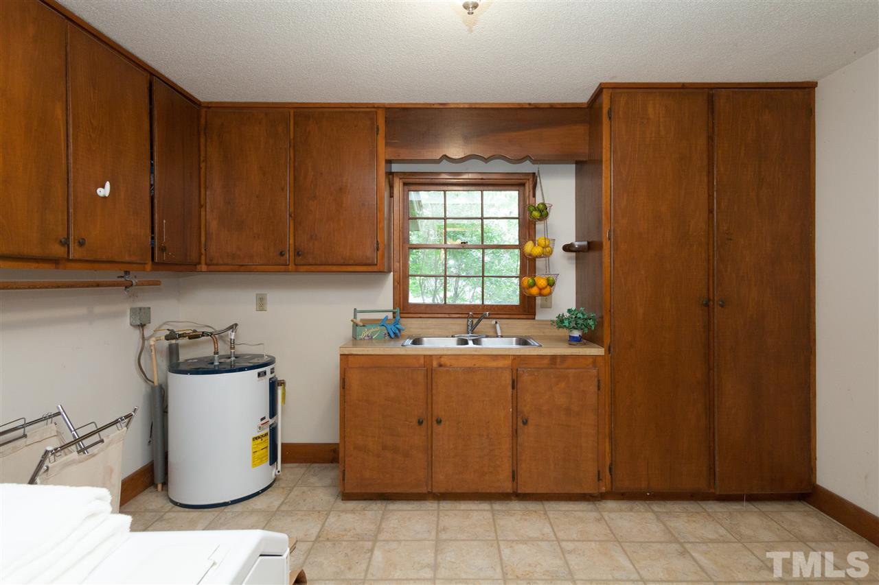 919 Grovemont Road Raleigh, NC 27603 - Photo 18 of 24 a kitchen with a refrigerator and washer