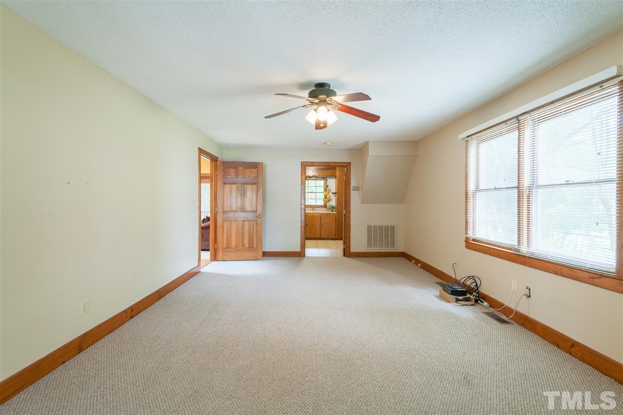 919 Grovemont Road Raleigh, NC 27603 - Photo 24 of 24 an empty room with chandelier fan and windows