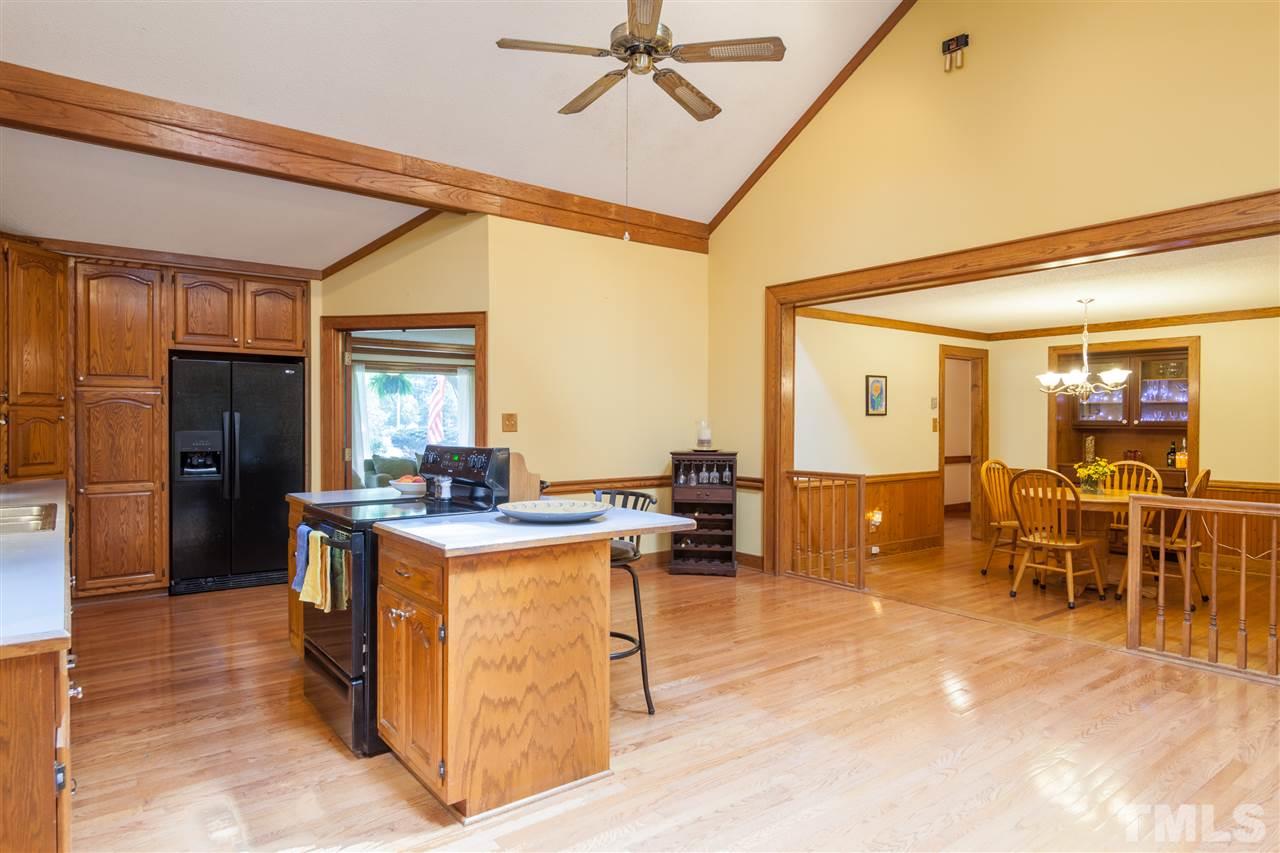 919 Grovemont Road Raleigh, NC 27603 - Photo 5 of 24 a view of a dining hall with couches and dinning table with wooden floor
