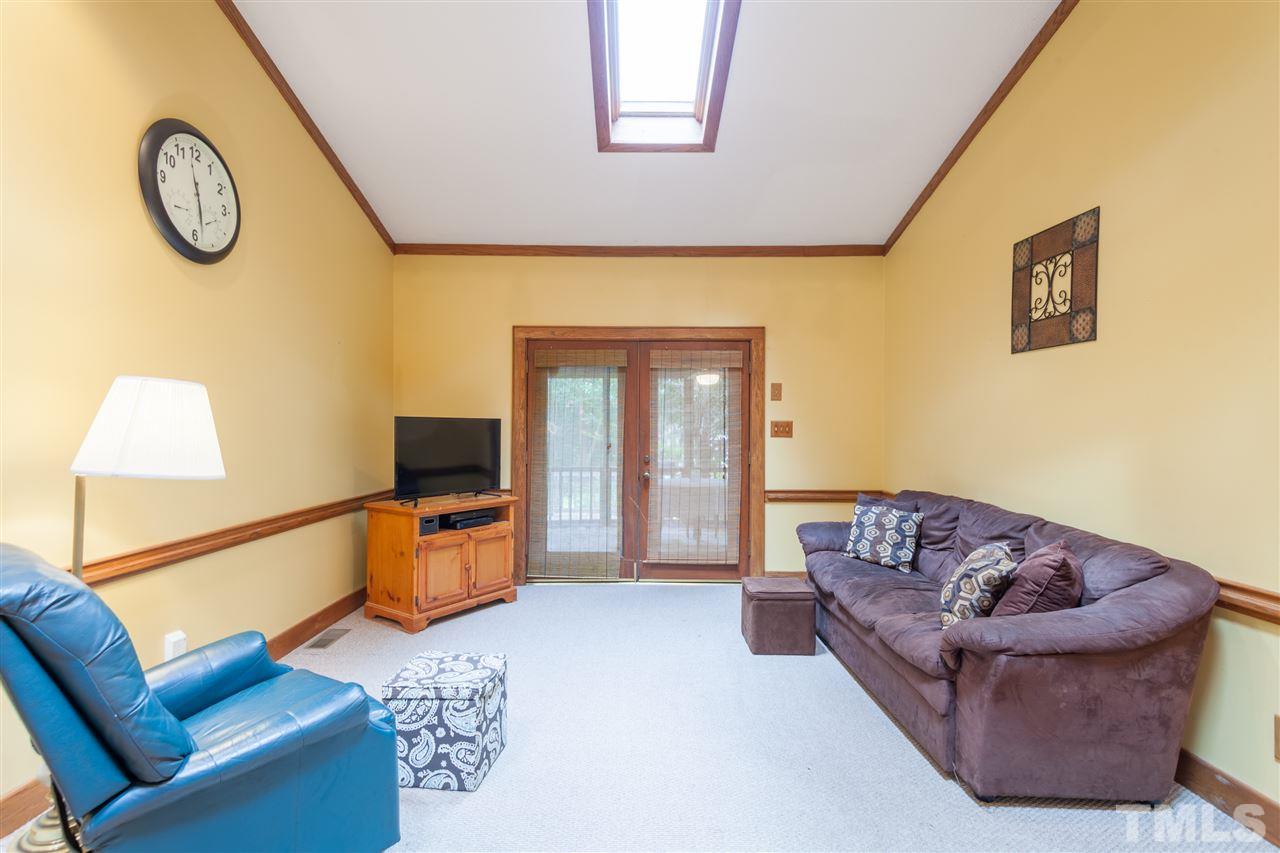 919 Grovemont Road Raleigh, NC 27603 - Photo 10 of 24 a living room with furniture and a flat screen tv
