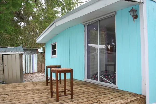 a view of a house with backyard and wooden fence