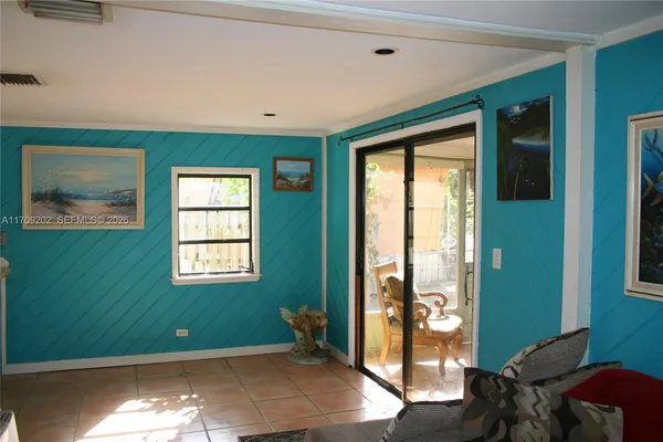 a room with painting and a window