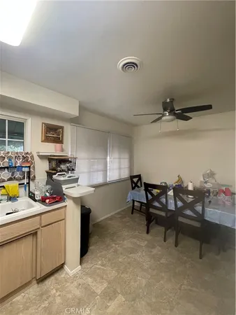 a kitchen with white cabinets and appliances
