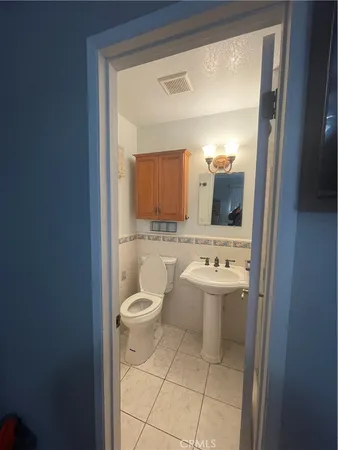 a bathroom with a sink shower and a mirror