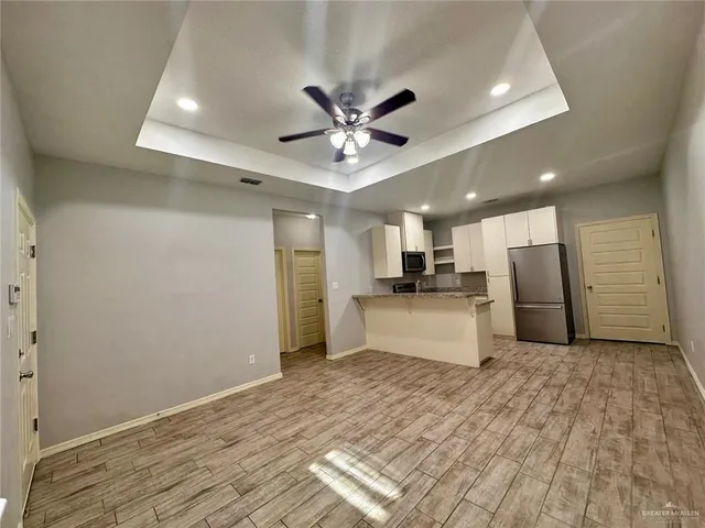 a view of kitchen with refrigerator sink and wooden floor