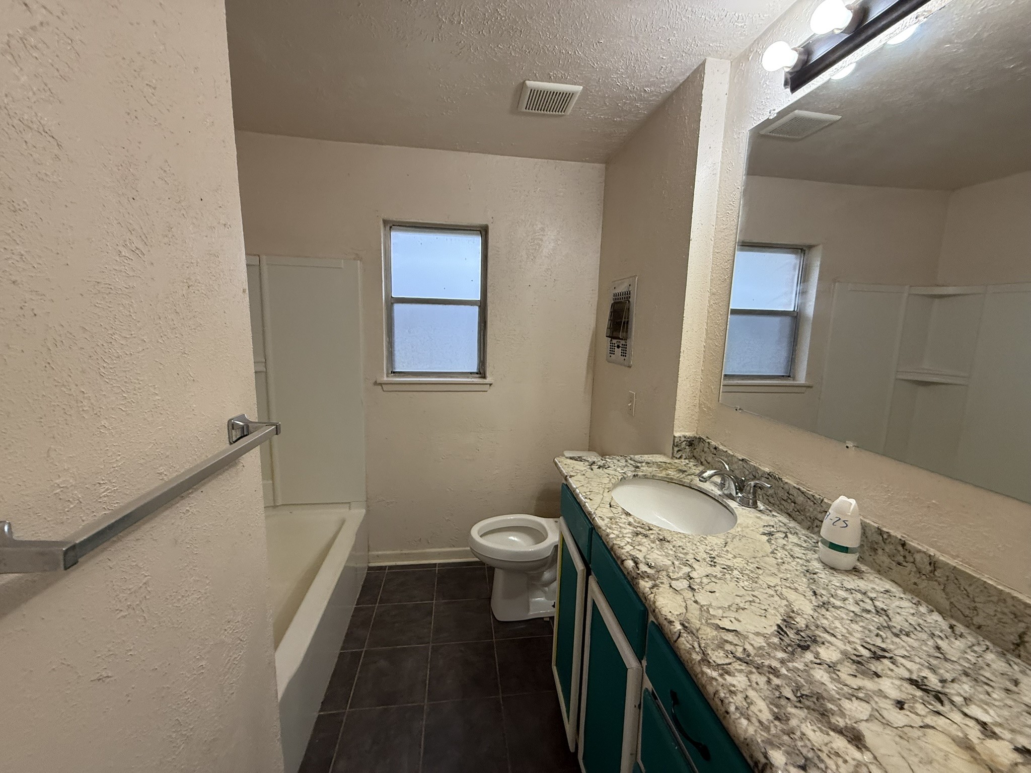 13907 Mueck Road Needville, TX 77461 - Photo 18 of 27 a bathroom with a granite countertop sink a toilet and a mirror
