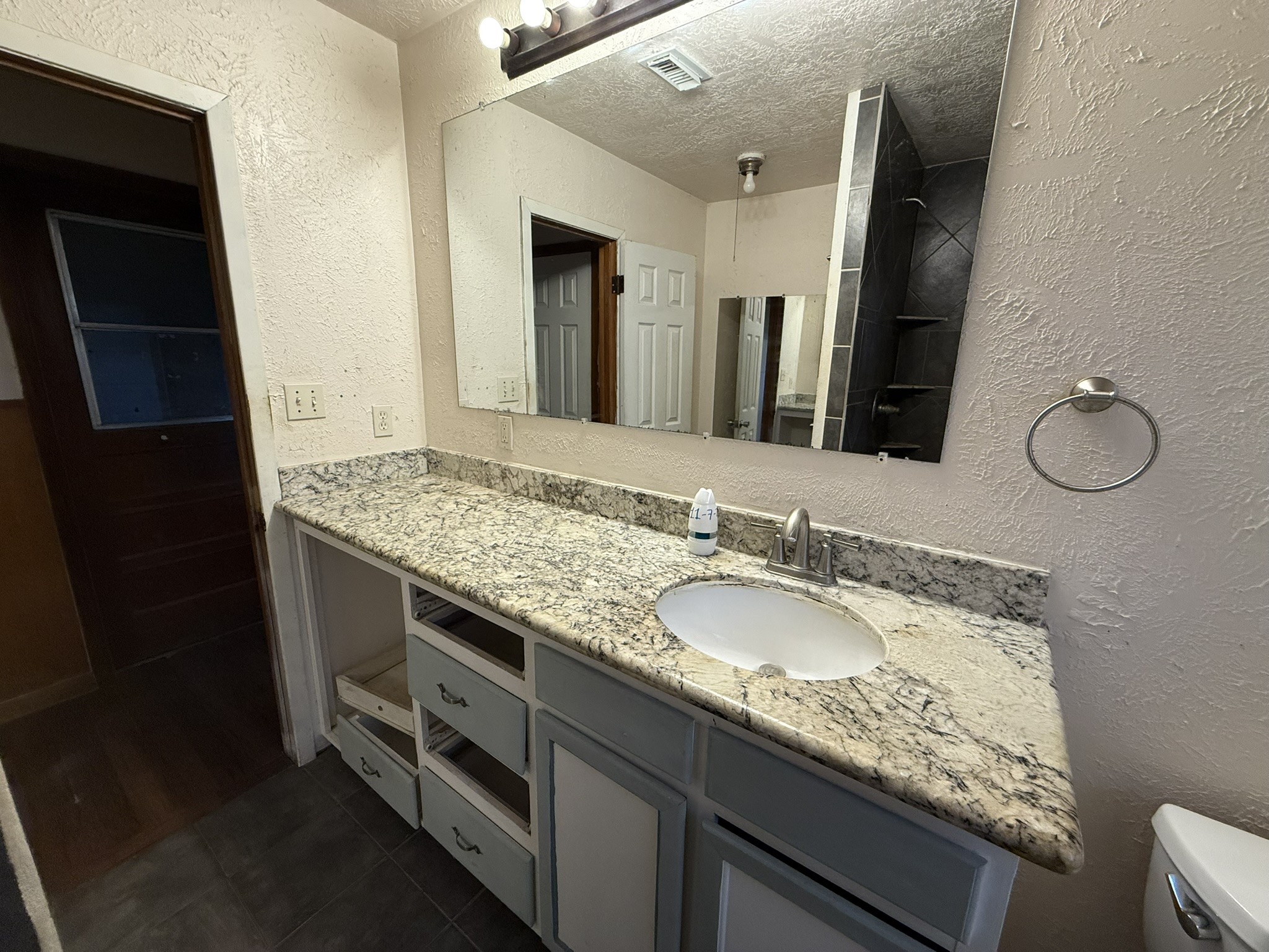 13907 Mueck Road Needville, TX 77461 - Photo 19 of 27 a bathroom with a granite countertop sink and a mirror