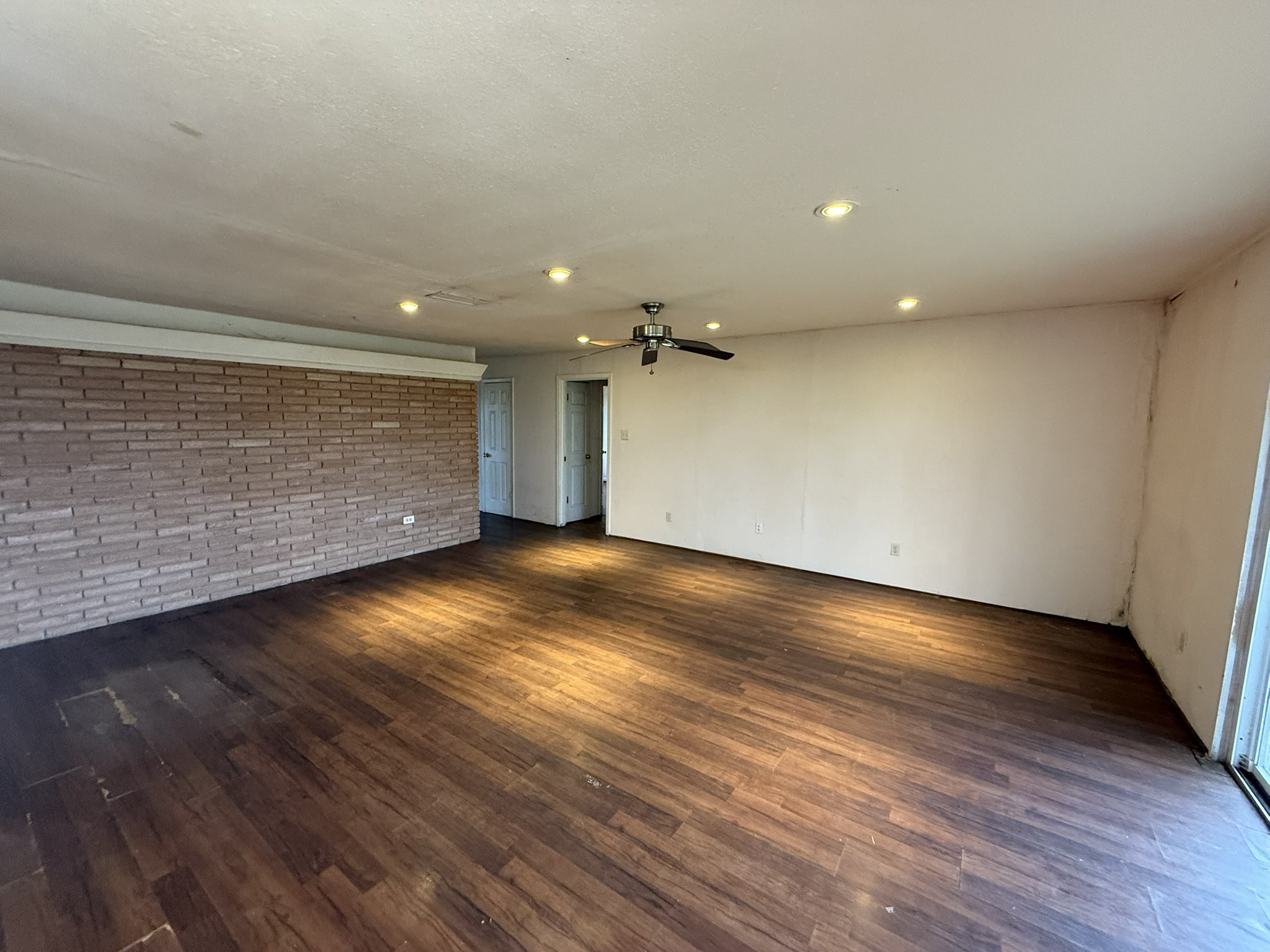13907 Mueck Road Needville, TX 77461 - Photo 6 of 27 an empty room with wooden floor and windows