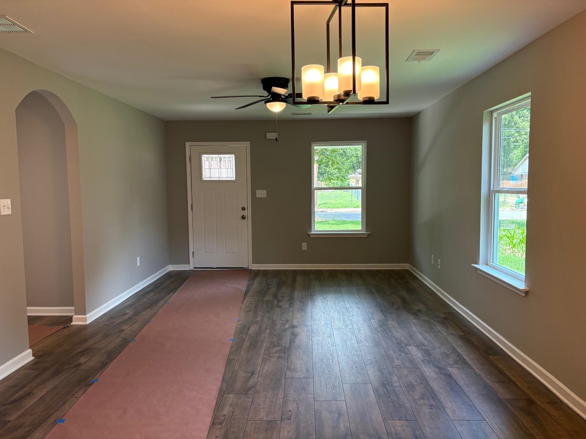 3701 Whittier Road Memphis, TN 38108 - Photo 2 of 13 Entrance foyer featuring dark wood-type flooring, a ceiling fan, and arched walkways