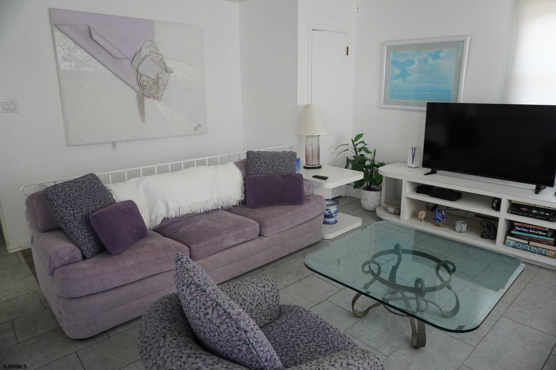 15 South Decatur Avenue, Unit B Margate City, NJ 08402 - Photo 11 of 27 a living room with furniture and a flat screen tv