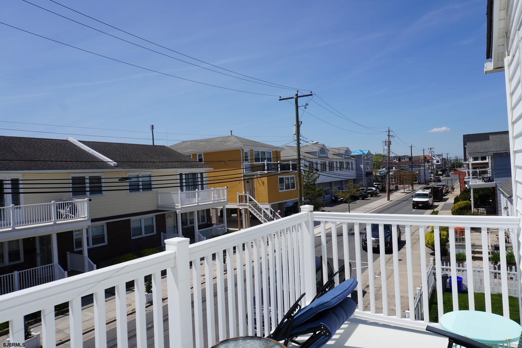 15 South Decatur Avenue, Unit B Margate City, NJ 08402 - Photo 13 of 27 a view of a balcony that has two chairs with wooden floor